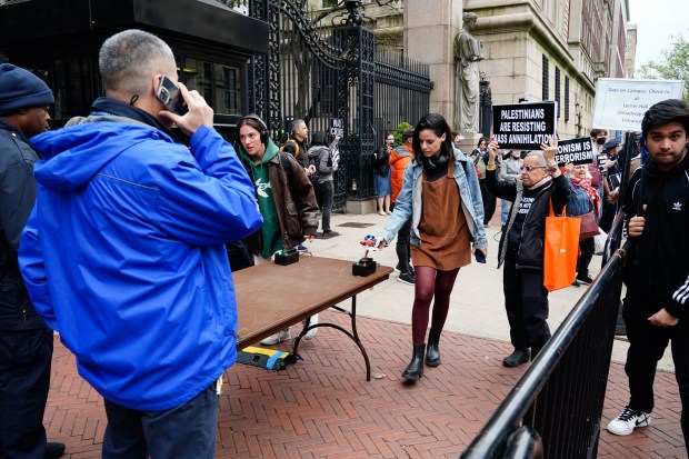Employees and students scan their IDs to get into the Columbia University campus as pro-Palestinian protestors rally on Broadway and W. 116th St. on Tuesday, April 17, 2024 in Manhattan, New York. (Barry Williams for New York Daily News)