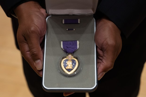 NYPD Sgt. Ruben Cespedes holds the Purple Heart that he was awarded Wednesday, Sept. 16, 2026 in Manhattan, New York. (Barry Williams/ New York Daily News)