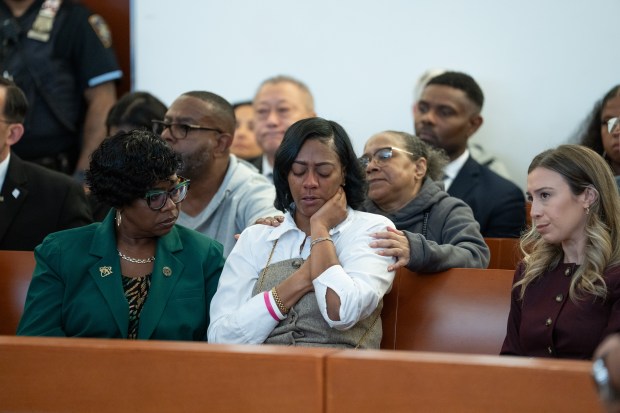 Lynette Pierce (center), the MTA subway conductor that Isaiah Thompson slashed is pictured in Bronx Criminal Court during Thompson's sentencing on Tuesday, September 22, 2026. Bronx DA Darcel Clark is pictured at left. (Barry Williams / New York Daily News)