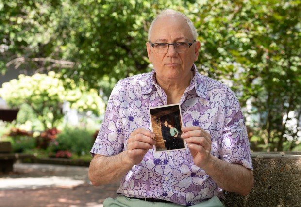 Charles Wolfe poses for a portrait with a photograph of his late wife, Katherine, on Friday, Sept. 4, 2026 in Manhattan, New York. On 9/11, Katherine was working in the World Trade Center's North Tower on the 97th floor, where, just weeks earlier, she had started an executive assistant job at Marsh & McLennan. No one above the 91st floor would survive the attack. (Barry Williams/ New York Daily News)