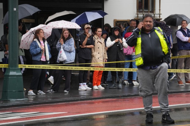 Bystanders watch as police investigate after a bicyclist was killed in a collision with a dump truck on West 34th St. in Manhattan on Monday, Sep. 28, 2026. (Barry Williams / New York Daily News)