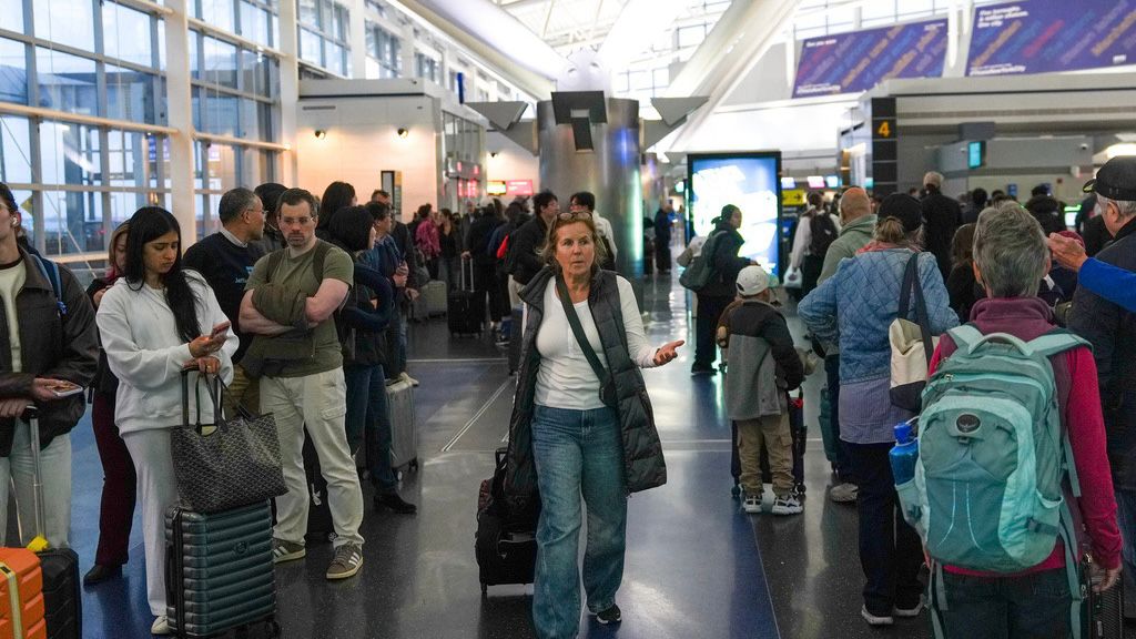 People wait in long TSA security lines at John F. Kennedy International Airport (JFK) in the Queens borough of New York, Monday, March 23, 2026.