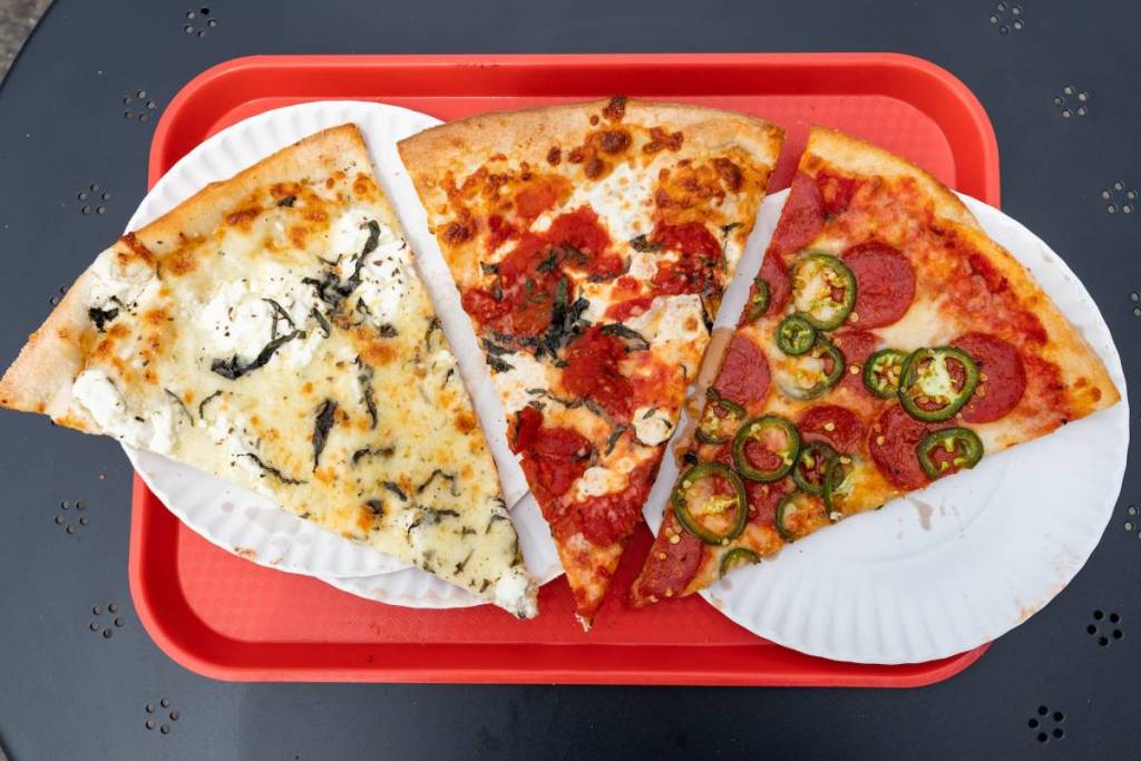 Three New York City Style Pizza Slices on a Red Tray
