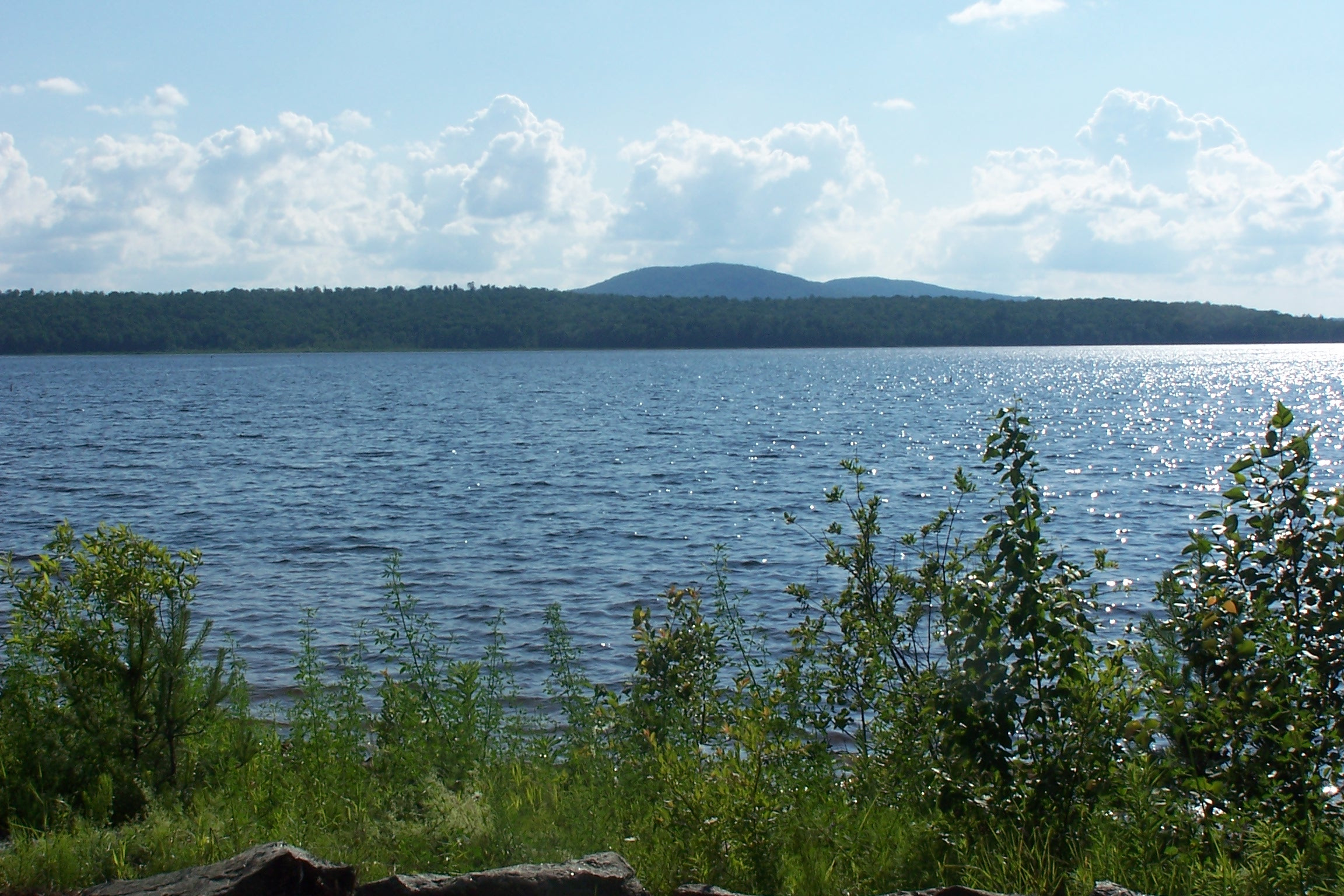 Big Tupper Lake, ringed by forest and low Adirondack peaks.