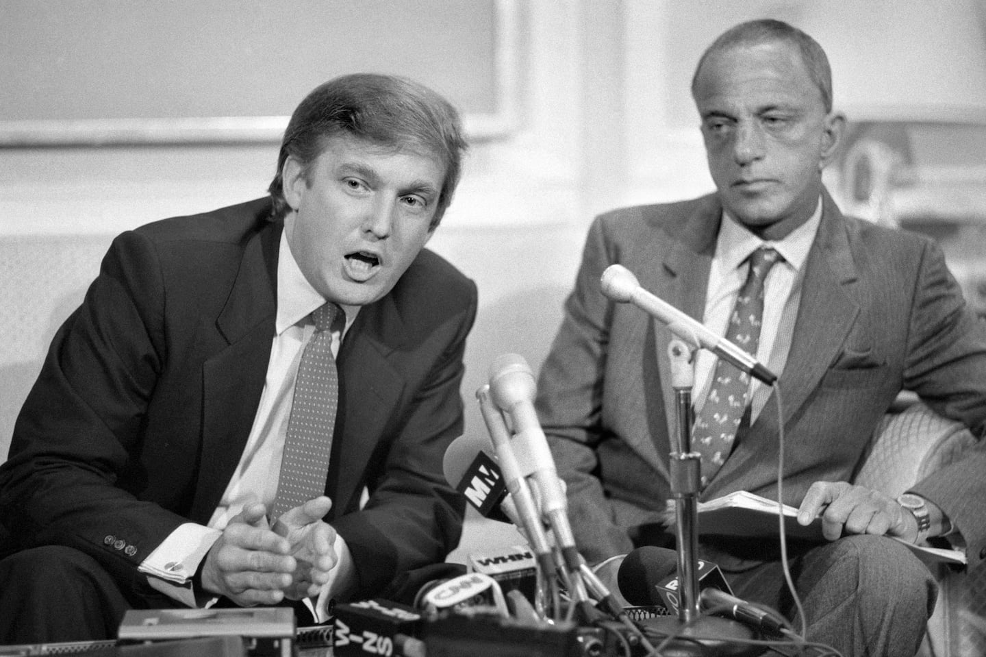 Donald Trump with Roy Cohn, then his lawyer, at a news conference where they announced a billion-dollar lawsuit against the National Football League in New York in October 1984.