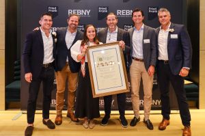 Preston Cannon (left) and Matt Chmielecki (right) of the REBNY Retail Committee present the Most Ingenious Retail Deal of the Year to the Cushman and Wakefield team who worked on the Urban Outfitters transaction at 575 Fifth Avenue.