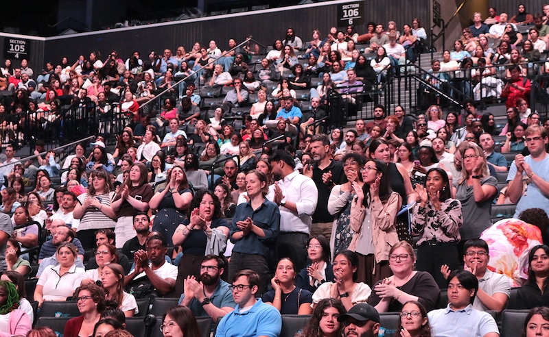 A crowd of people fills an arena.