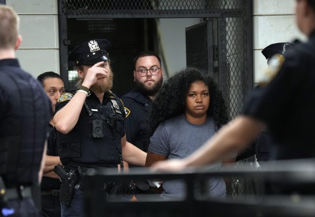 Alejandra Paharsingh is pictured in police custody leaving the NYPD's Midtown South Precinct stationhouse in Manhattan on Wednesday, Sept. 9, 2026. Paharsingh was allegedly behind the wheel during a Midtown Manhattan Tesla crash earlier in the day. (Barry Williams / New York Daily News)
