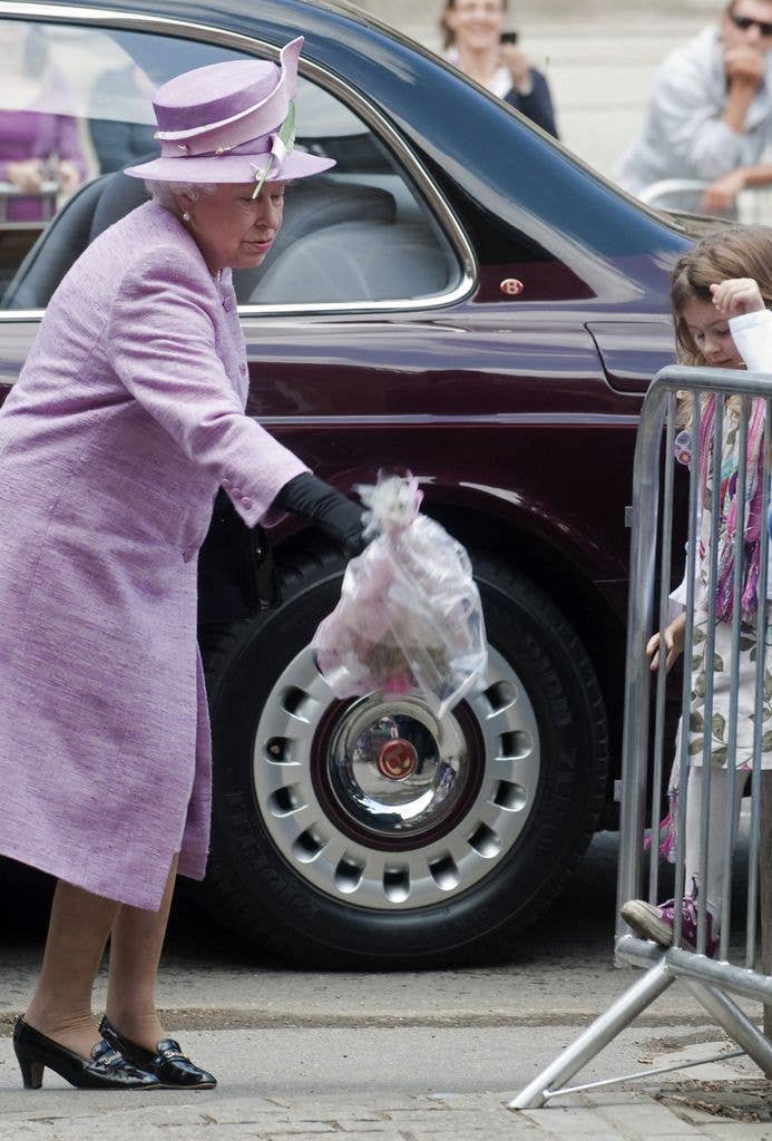 The late Queen dropping a bouquet of flowers while visiting Eton College