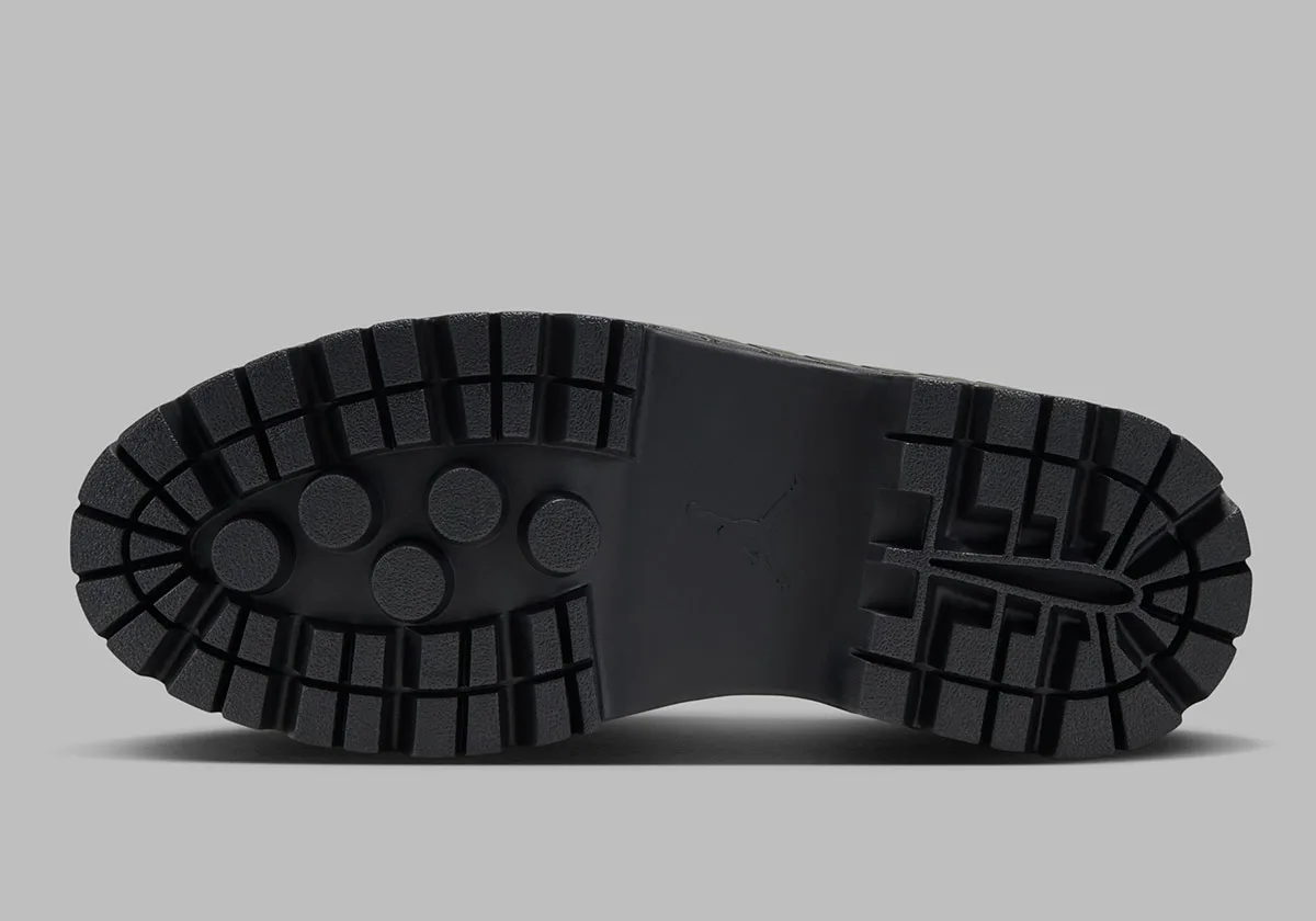 outsole close-up showing block tread ridges and jumpman logo in black rubber, Jordan 1 Brooklyn