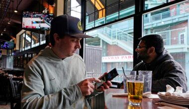 Man at bar holding a phone
