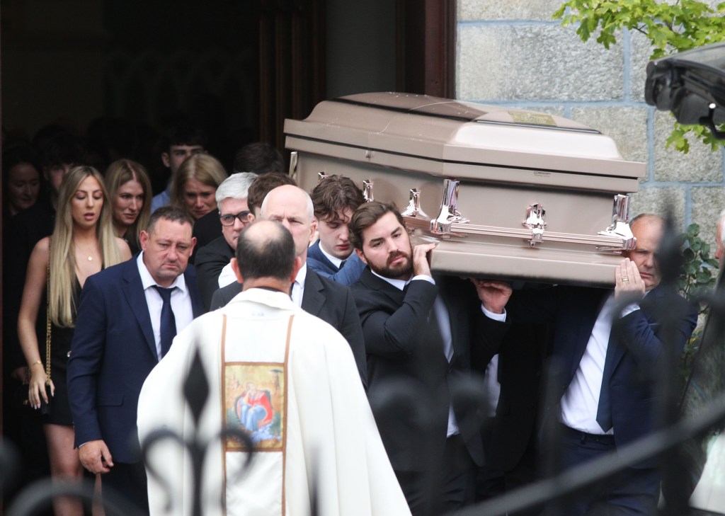 Nicholas DiRubio helps carry the casket of Martha Nolan at her funeral.