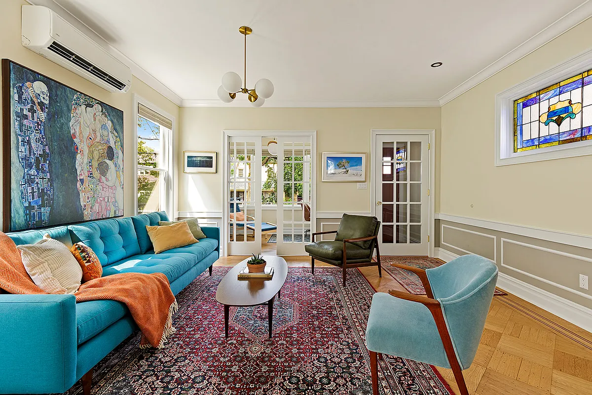 living room with wainscoting, wood floor