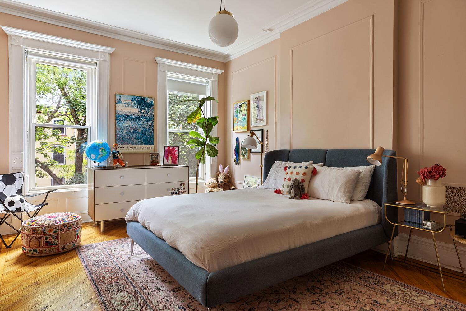 bedroom with wall moldings, two windows