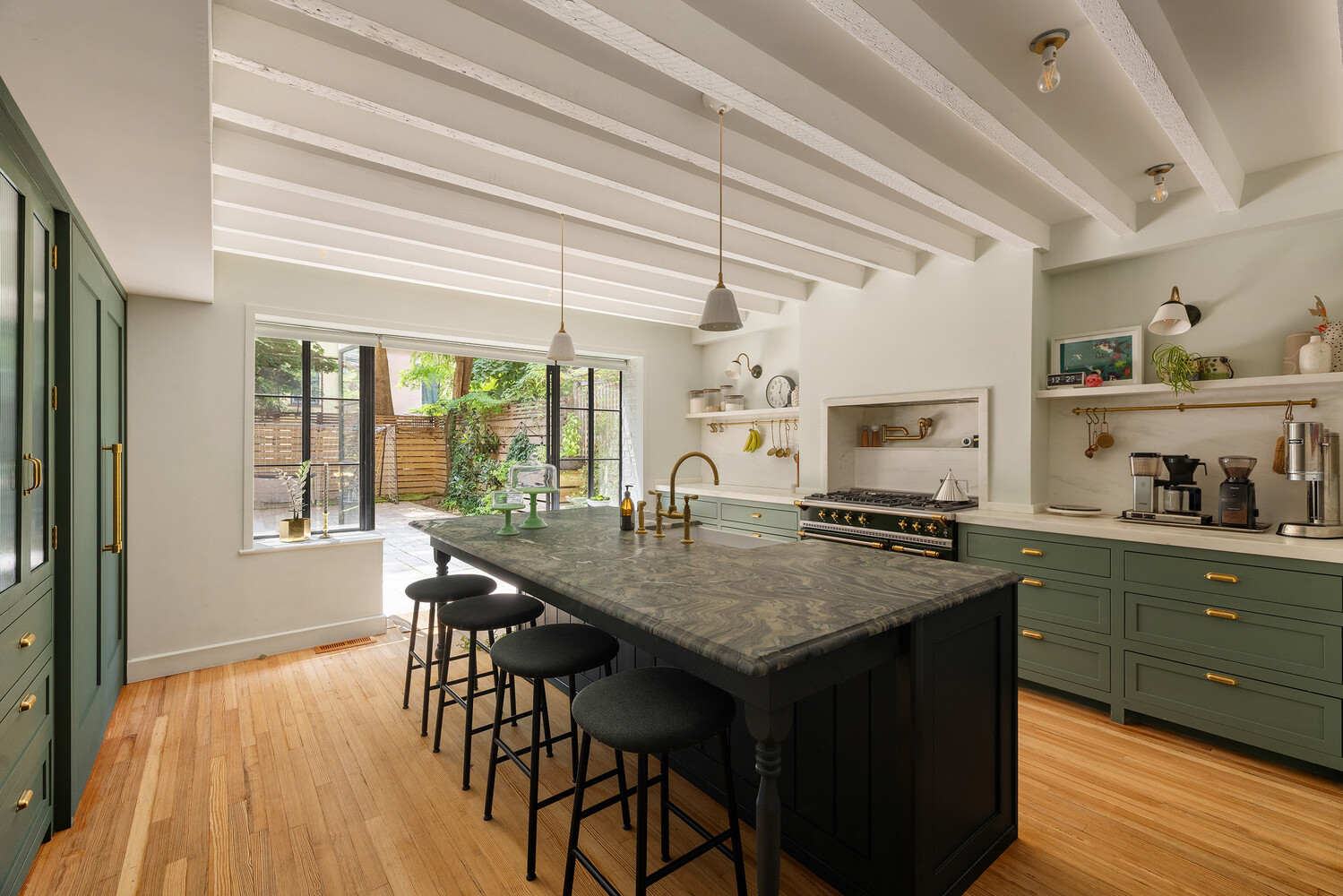 kitchen with large island and green cabinets