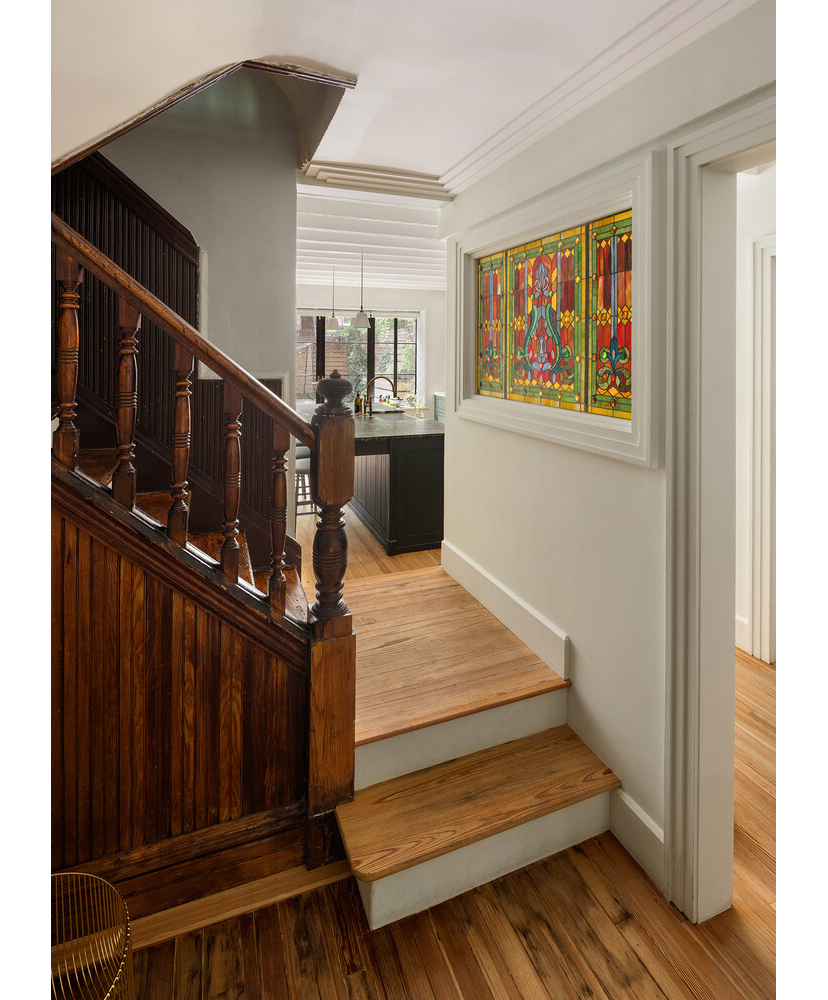 stair landing with view into garden level kitchen