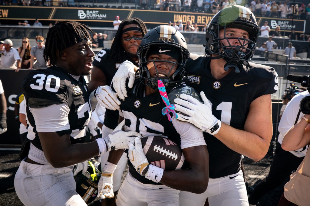 Vanderbilt cornerback Cayden Daniels (26) celebrates his game-winning touchdown with his teammates.