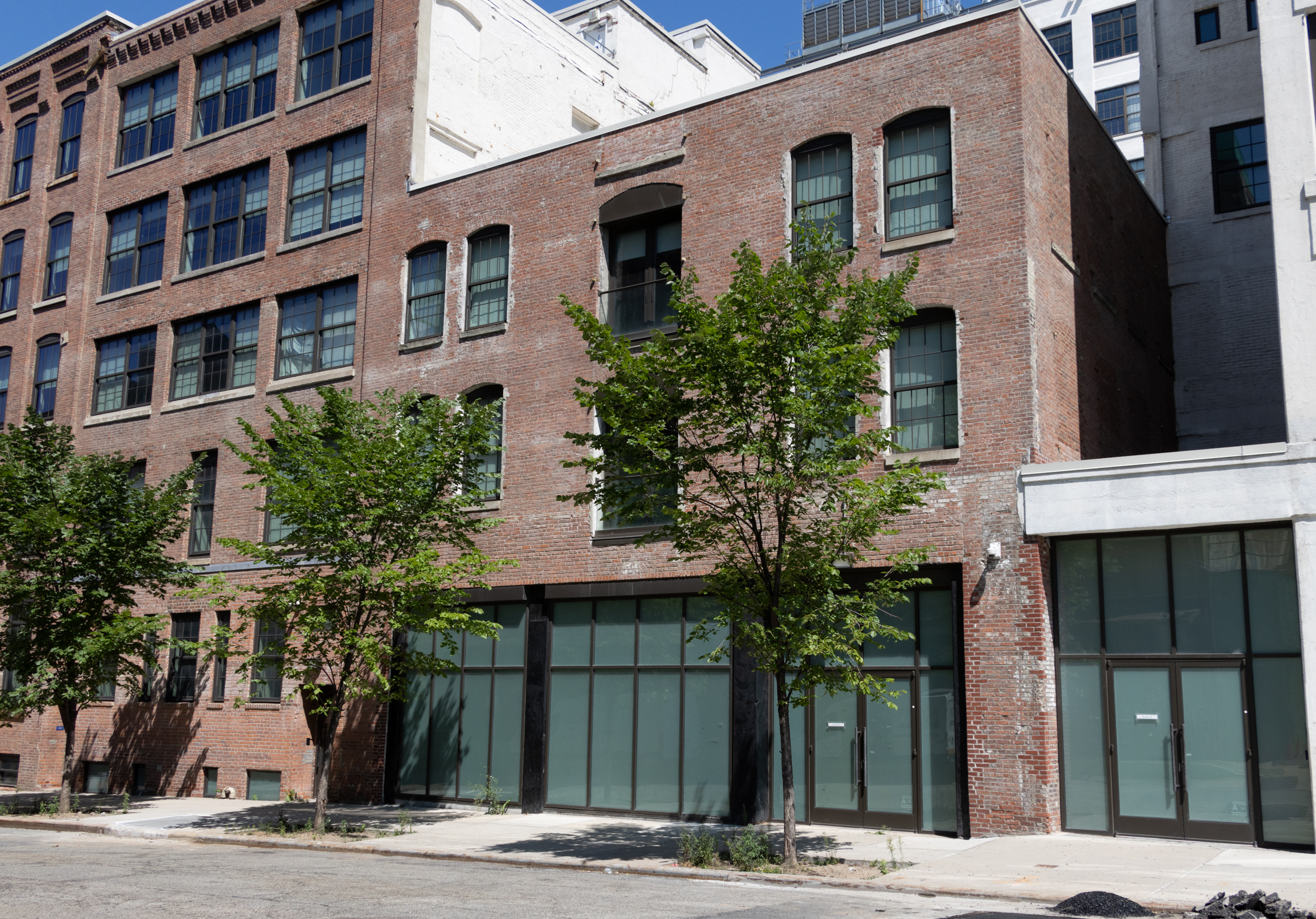 a low scale brick industrial building with a new storefront
