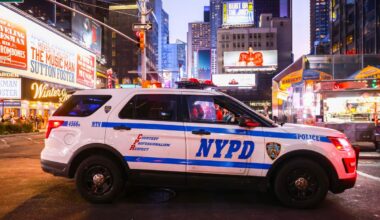 Shocking video shows wrong-way BMW racing off, hurling armed cop to ground in Times Square