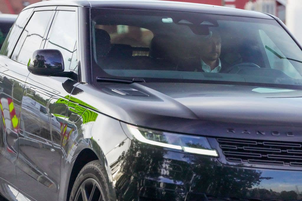 King Haakon pictured driving away from the  National Hospital in Oslo on Monday