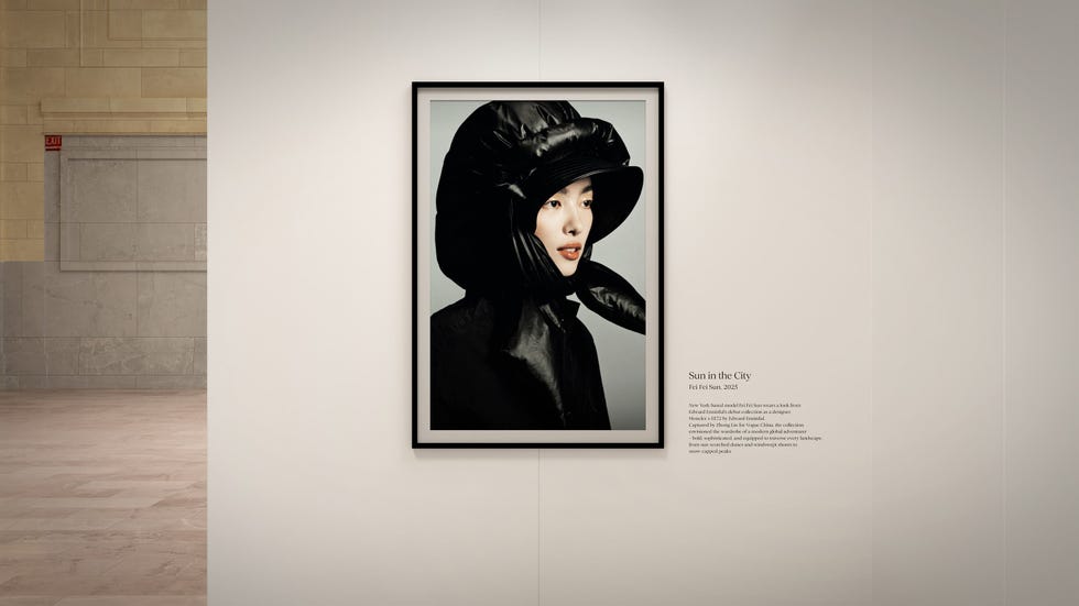 A portrait of a woman in a black hat and coat displayed in an art gallery setting.