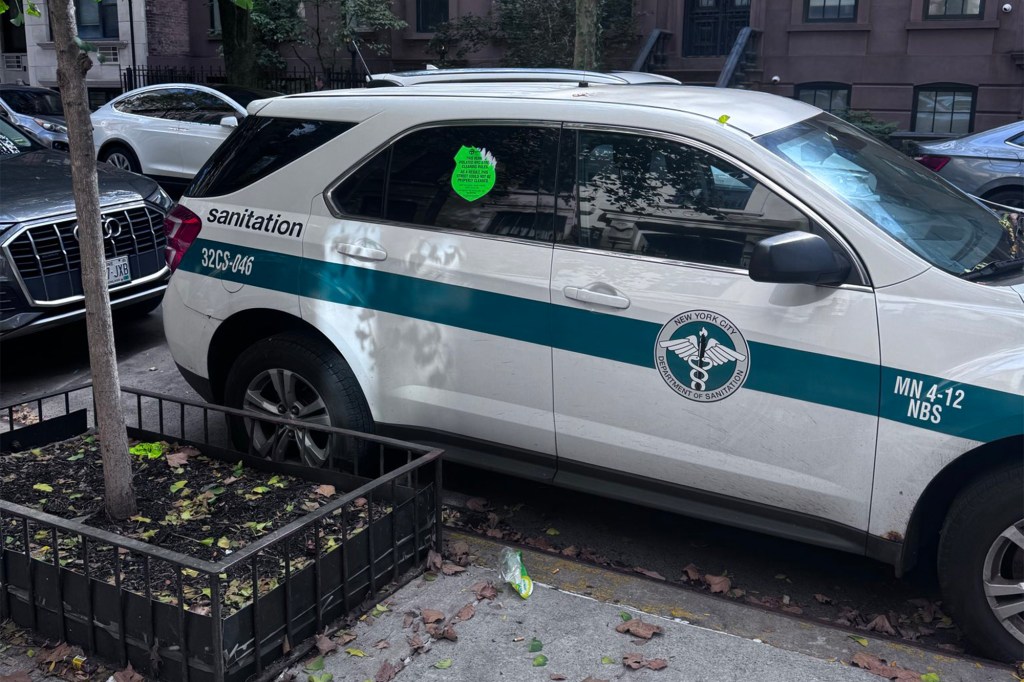 A New York City Department of Sanitation vehicle with a green "shame sticker" on its window, stating "THIS VEH. VIOLATED NYC STREET CLEANING RULES, AS A RESULT THIS STREET COULD NOT BE PROPERLY CLEANED."