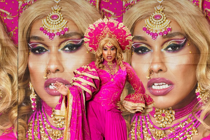 Lucky Roy Singh wearing a pink dress, posing ahead.