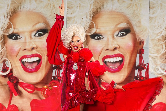 Ma Danni wearing a red outfit with one arm in the air.