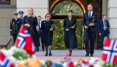 Queen Mette-Marit , Queen Sonja, Princess Martha Louise and King Haakon wearing black outfits holding roses