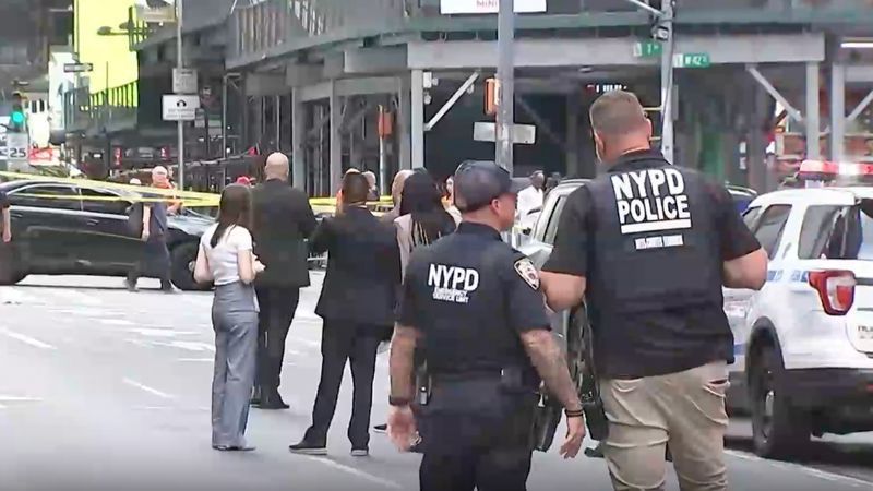 This image made from video provided by WABC shows NYPD officers on the scene after a woman brandishing two large knives was shot by officers in Times Square in New York, Monday, Aug. 31, 2026. (WABC via AP)