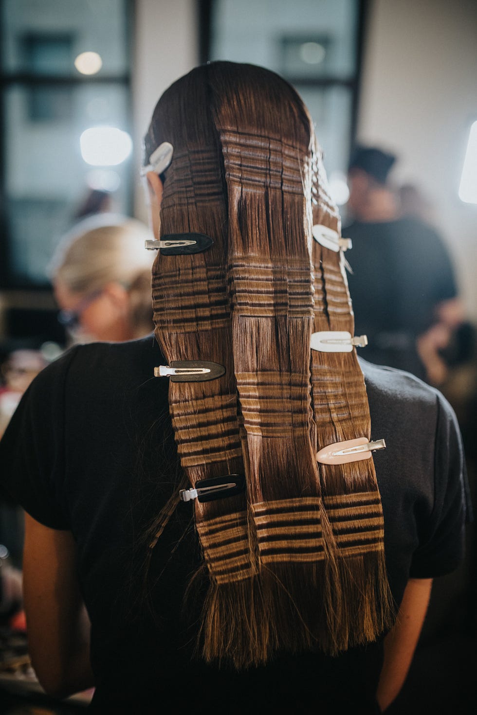 Long, pinned hair with unique textured sections, styled for an artistic look at a fashion event. Long, pinned hair with unique textured sections, styled for an artistic look at a fashion event.