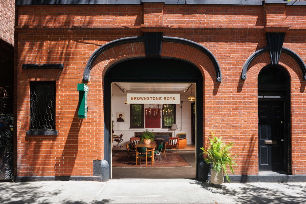 Entrance to a cozy interior space with rustic decor and a sign reading "BROWNSTONE BOYS".