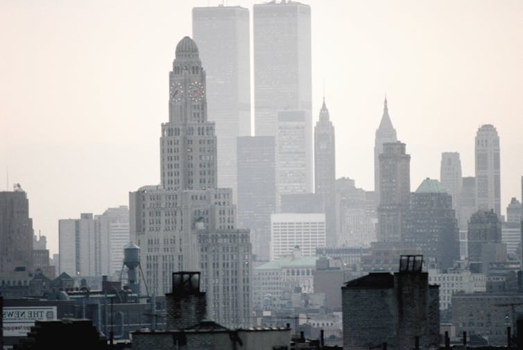 View of Manhattan towers, with the Empire State Building in the foreground and the Twin Towers behind.