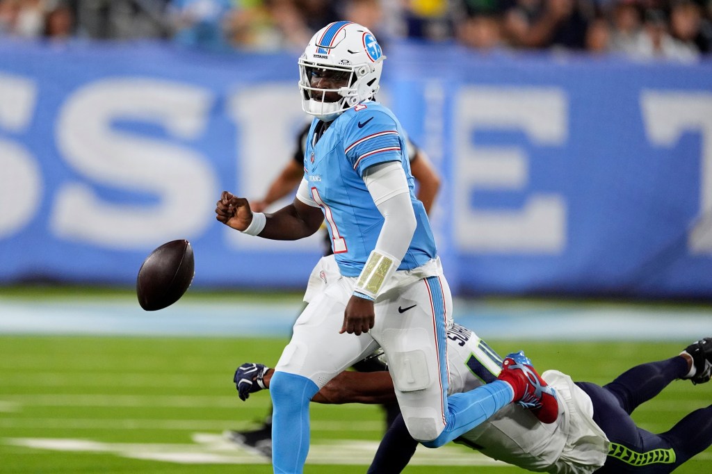 Tennessee Titans quarterback Cam Ward fumbles the ball as he is hit by Seattle Seahawks linebacker Chazz Surratt during a preseason NFL football game.