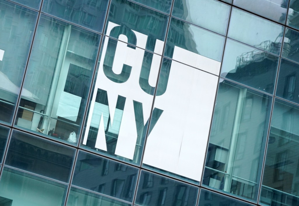 A building with glass windows, reflecting "CUNY" in white block letters.