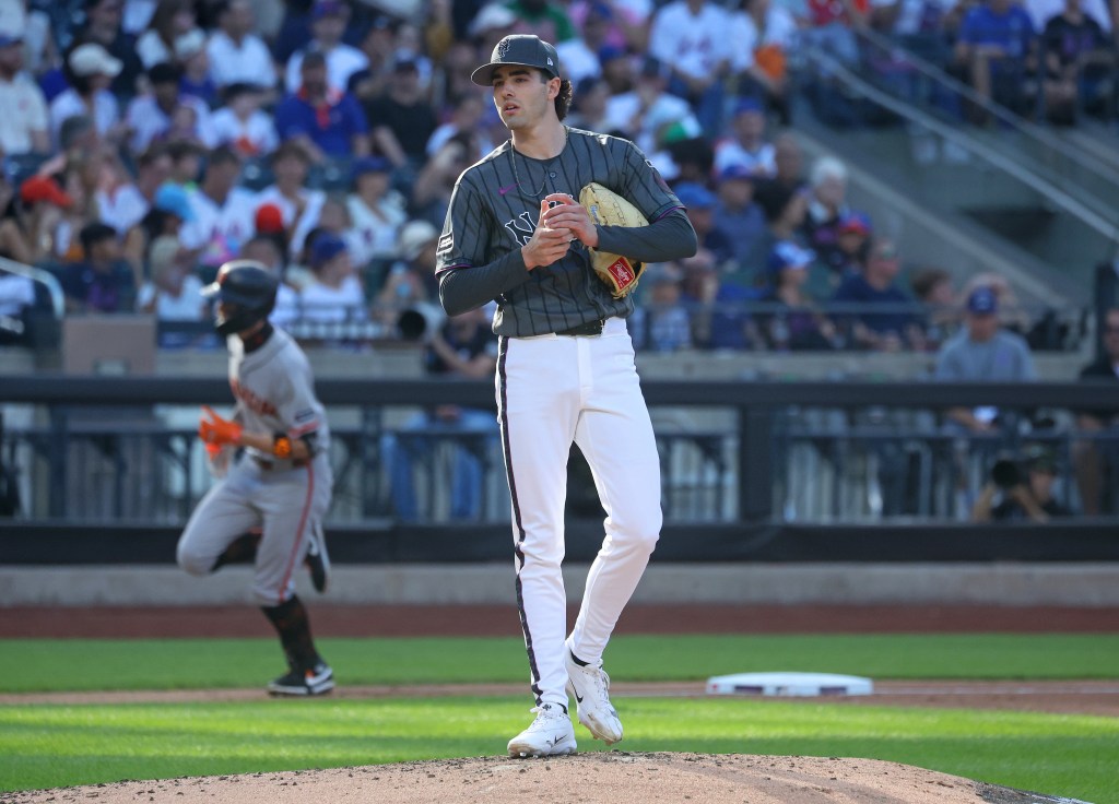 New York Mets pitcher Zac Thornton (49) on the mound as San Francisco Giants third baseman Christian Koss (50) runs in the background.