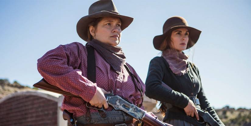 Mary Agnes (Merritt Wever) and Alice Fletcher (Michelle Dockery) holding rifles in Godless.