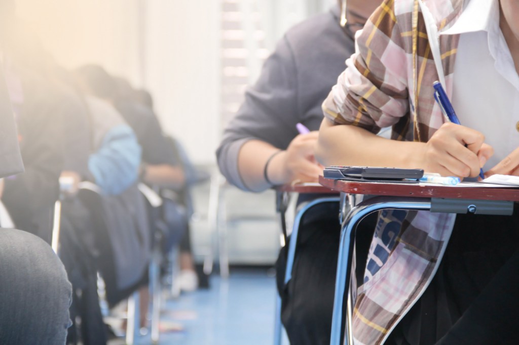 Students taking an exam in a classroom.