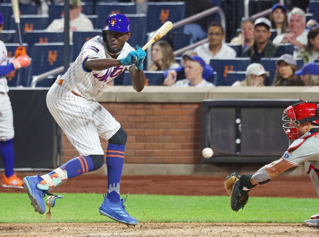 New York Mets' Ronny Mauricio is hit by a pitch.