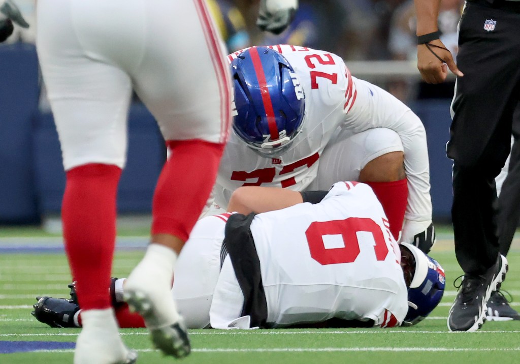 Giants quarterback Jaxson Dart (6) takes a hard hit and is checked by a teammate before coming out of the game during the first quarter against the Los Angeles Rams at SoFi Stadium in Inglewood, California, Monday, September 21, 2026.