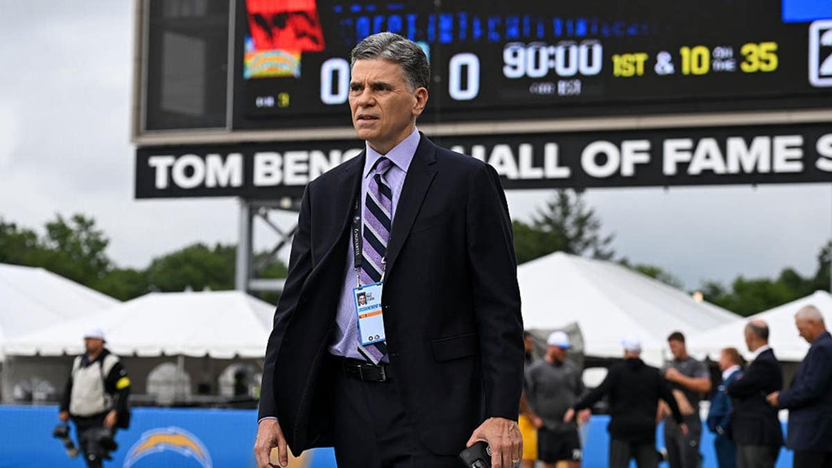 Mike Florio, NBC Sports commentator, looks on near the field at Tom Benson Hall of Fame Stadium in Canton, Ohio.