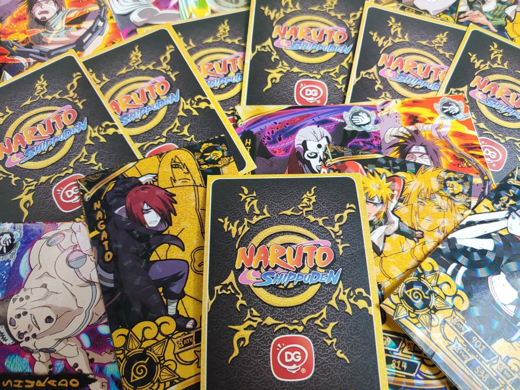 Naruto collectible trading cards with illustrations of various characters from the series.