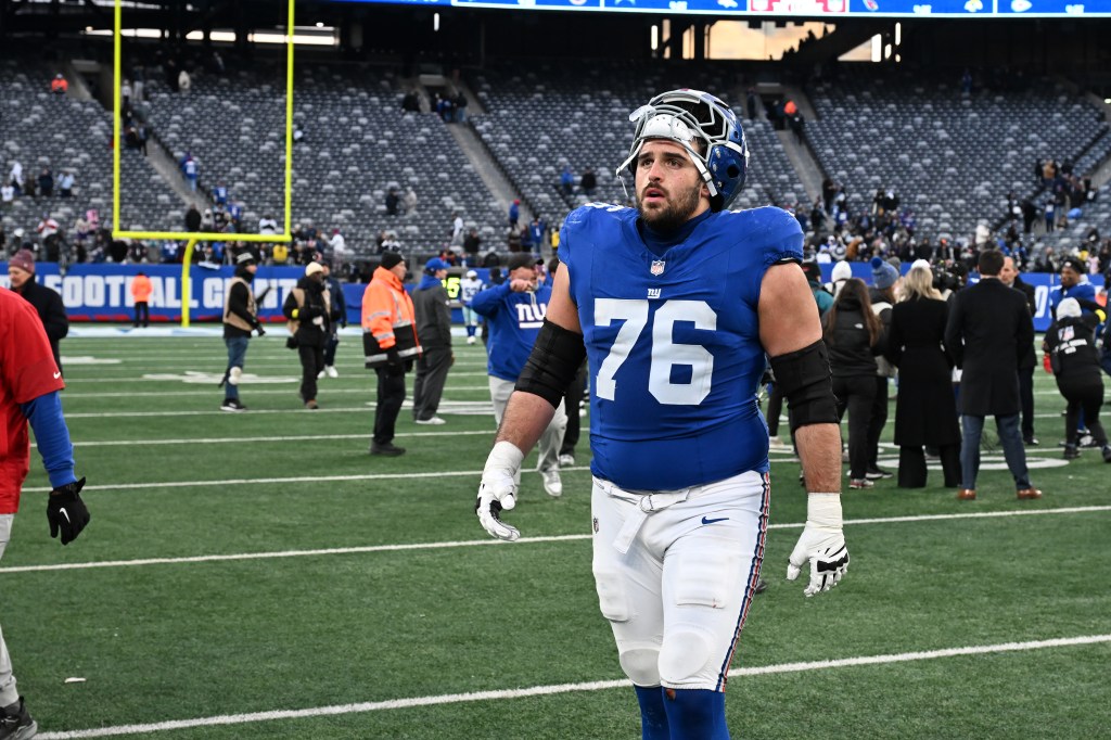 New York Giants guard Jon Runyan (76) on the field after a victory.