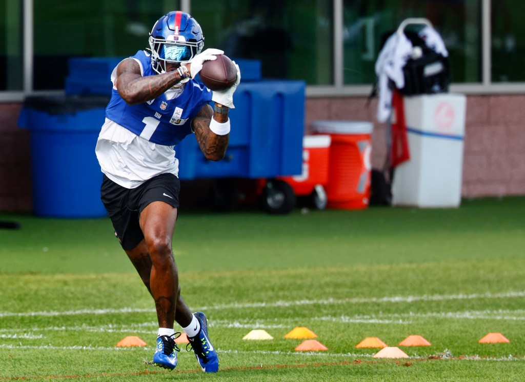 New York Giants wide receiver Malik Nabers catching a football during practice.