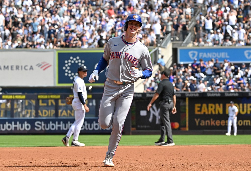 New York Mets right fielder Carson Benge smiles while rounding the bases after hitting a home run.