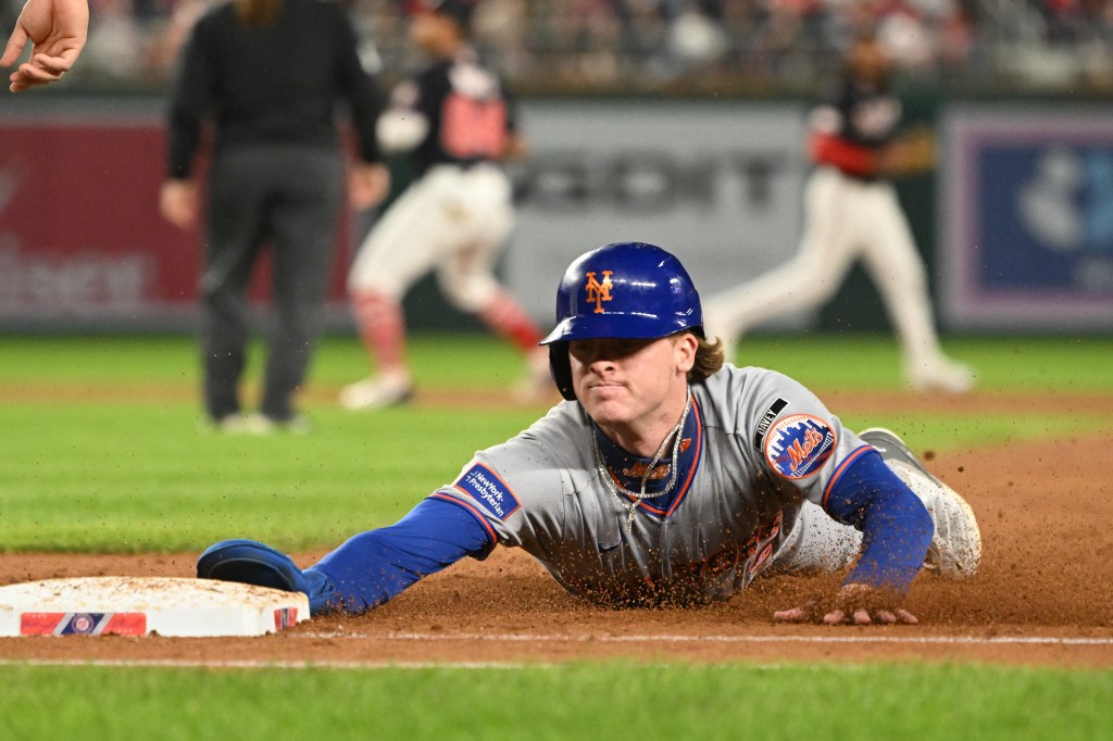 New York Mets right fielder Carson Benge slides back to first base.