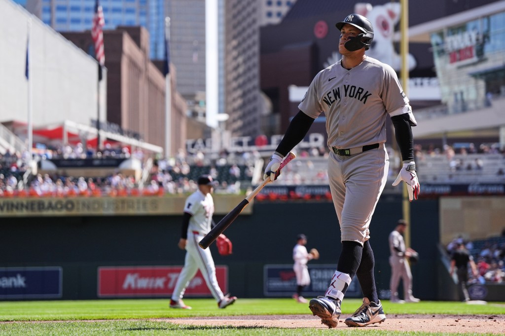 Aaron Judge of the New York Yankees walks back to the dugout with a bat after striking out.