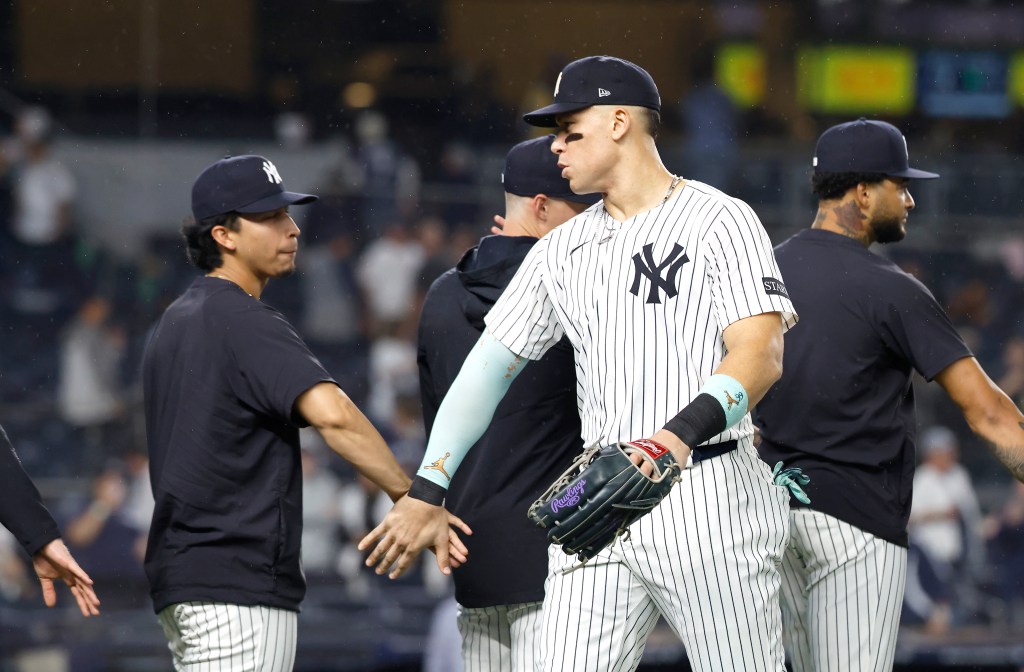 Aaron Judge high-fives Oswaldo Cabrera after the final out of the ninth inning.