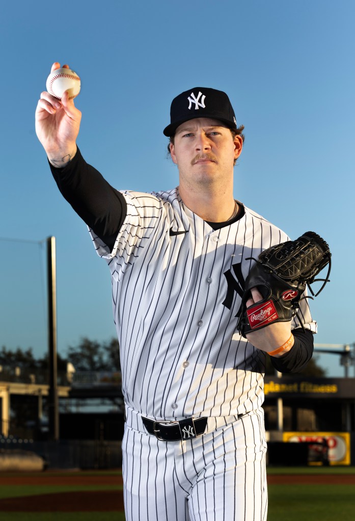 New York Yankees pitcher Chase Hampton in uniform holding a baseball.