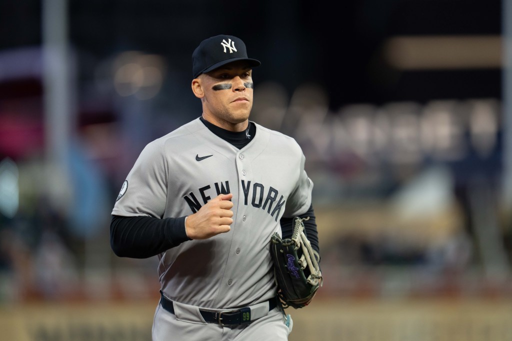 New York Yankees right fielder Aaron Judge in uniform runs off the field after the first inning against the Minnesota Twins.